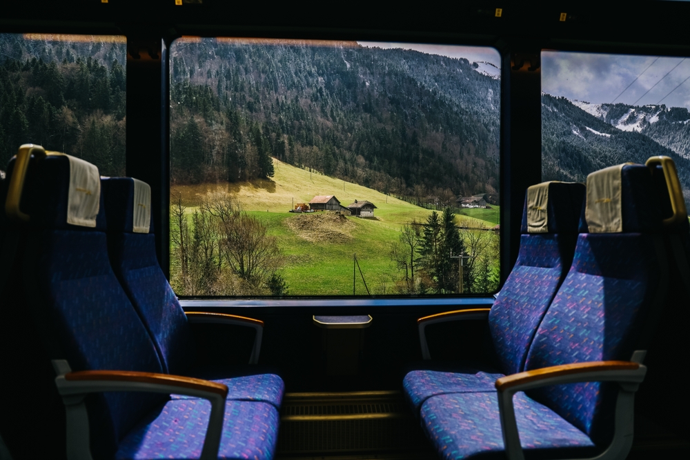 View out the train window in Switzerland with mountain from the window of Golden pass line train, Zweisimmen to Montreux. Soft and blur focus