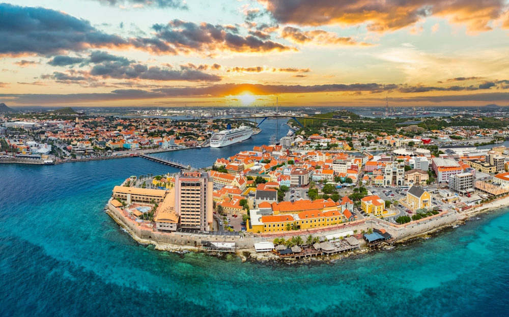 aerial photo of waterways and islands that are close together and part of a city, bridges are connecting the islands, photo taken at sunset 