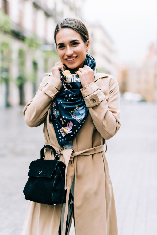 a woman with purse, scarf and coat perfect accesories for europe packing list