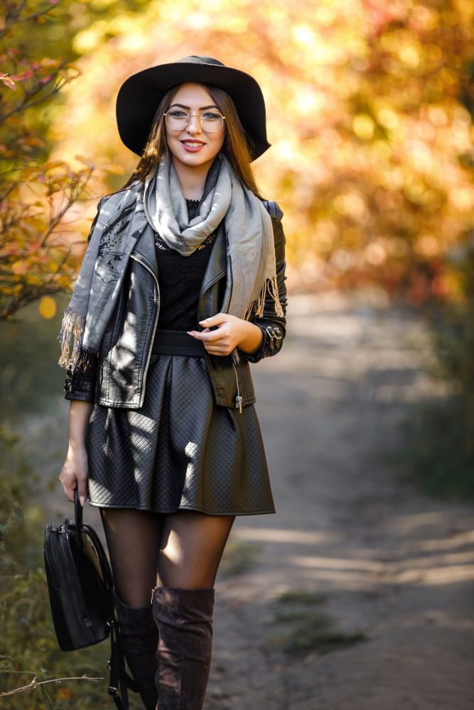 on this europe packing list you will need to pack neutrals in all black skirt, boots, and jacket outfit