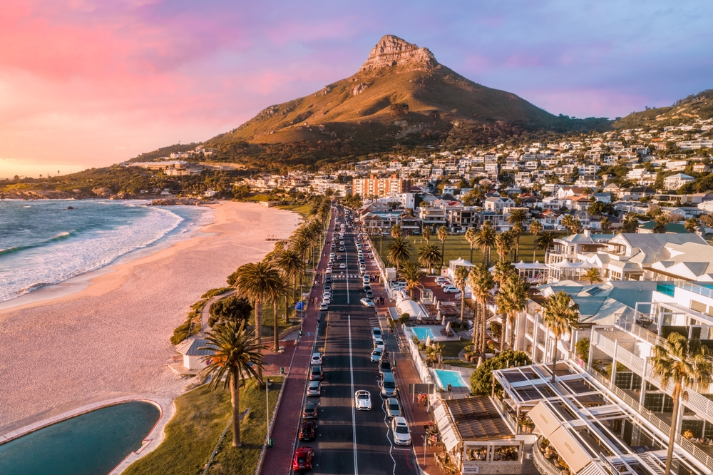 In Cape Town, the natural beaches back up to palm trees and streets of beachy buildings, with hills rolling in the distance. 