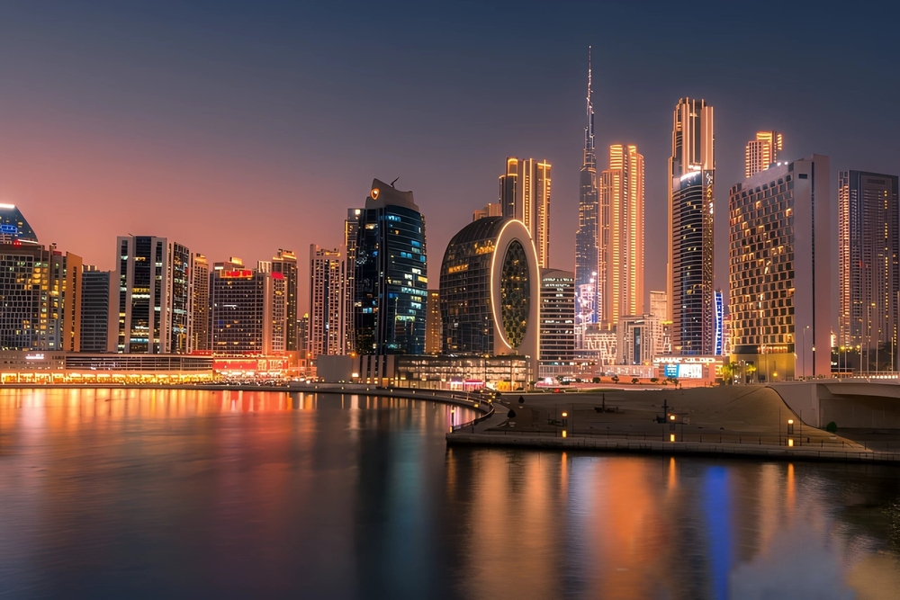 A futuristic shot of Dubai shows why this city is worth a iconic World Trips to Take in 2026: the tall buildings and iconic designs on the water light up at night. 