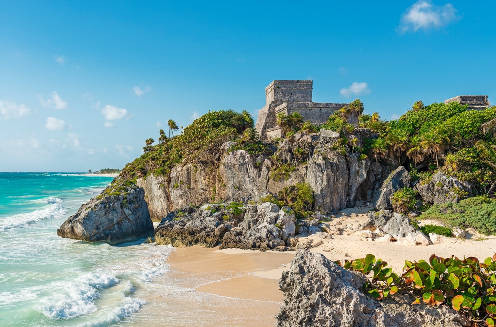 Mexico beaches are famous for their white sand, blue waters, and rocky formations. Here, the waves crash the shore and rocks line the beaches, with ruins towering on the rocky hills