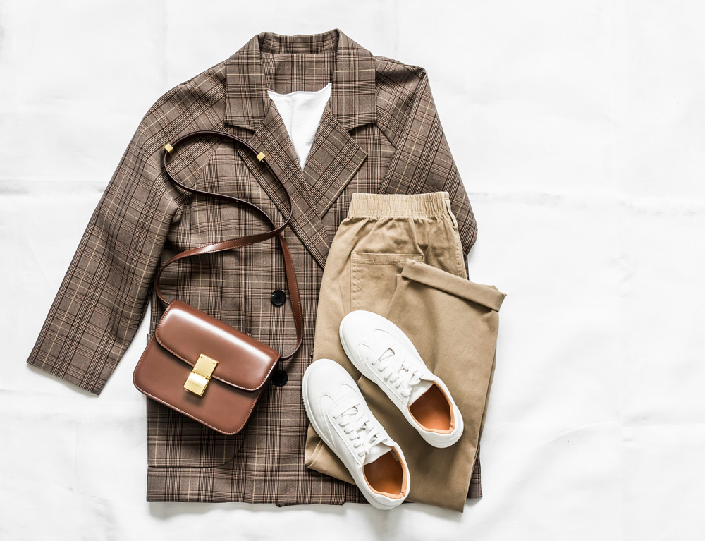 a flat lay of womens neutral pallet for Europe packing list