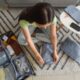 a woman sitting on the floor with a carry on suitcase with packing cubes